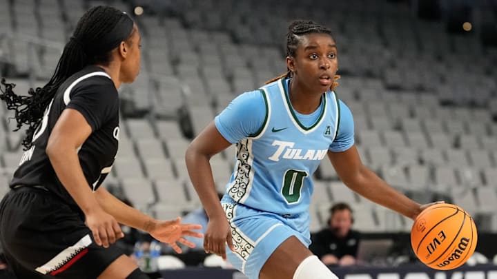 Mar 6, 2023; Fort Worth, TX, USA; Tulane Green Wave guard Kyren Whittington (0) controls the ball against Cincinnati Bearcats guard Mya Jackson (23) during the first half at Dickies Arena.