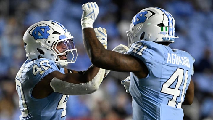 Nov 8, 2025; Chapel Hill, North Carolina, USA;  North Carolina Tar Heels linebacker Tyler Thompson (40) reacts with linebacker Jonathan Agumadu (41) after a sack in the fourth quarter at Kenan Stadium. Mandatory Credit: Bob Donnan-Imagn Images