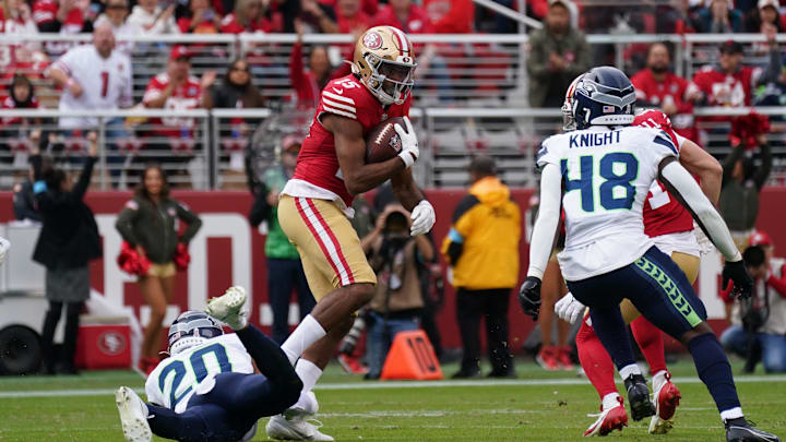 Nov 17, 2024; Santa Clara, California, USA; San Francisco 49ers wide receiver Jauan Jennings (15) makes a reception between Seattle Seahawks safety Julian Love (20) and Seattle Seahawks linebacker Tyrice Knight (48) in the first quarter at Levi's Stadium. Mandatory Credit: David Gonzales-Imagn Images