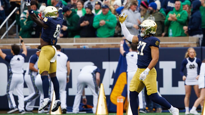 Notre Dame linebacker Kyngstonn Viliamu-Asa (27) and safety Adon Shuler (8) celebrate picking up a Virginia fumble on the opening kick off of during a NCAA college football game at Notre Dame Stadium on Saturday, Nov. 16, 2024, in South Bend.