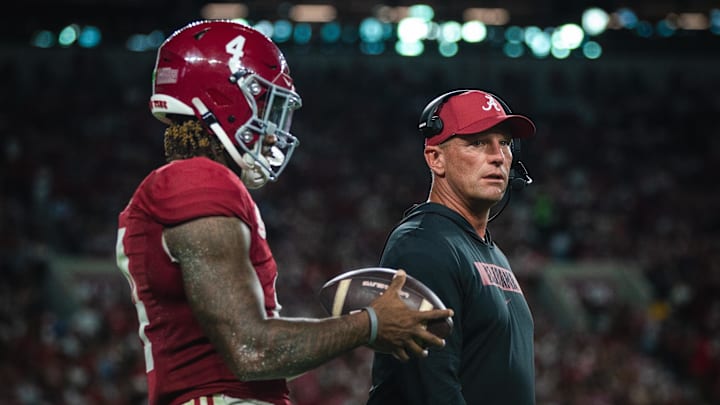 Sep 28, 2024; Tuscaloosa, Alabama, USA; Alabama Crimson Tide quarterback Jalen Milroe (4) and head coach Kalen DeBoer during a timeout in the first quarter against the Georgia Bulldogs at Bryant-Denny Stadium Sep 28, 2024; Tuscaloosa, Alabama, USA; Alabama Crimson Tide quarterback Jalen Milroe (4) and head coach Kalen DeBoer during a timeout in the first quarter against the Georgia Bulldogs at Bryant-Denny Stadium