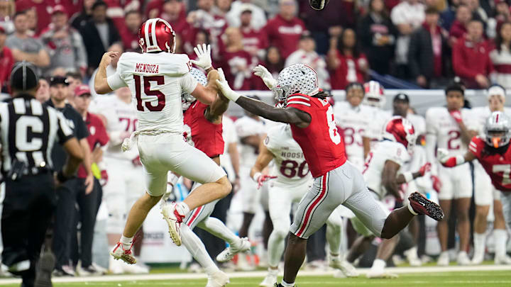 Ohio State Buckeyes linebacker Arvell Reese (8) pressures Indiana Hoosiers quarterback Fernando Mendoza (15) during the first half of the Big Ten Conference championship game at Lucas Oil Stadium in Indianapolis on Dec. 6, 2025.