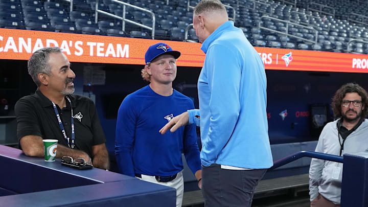 Sep 13, 2025; Toronto, Ontario, CAN; Toronto Blue Jays first round draft pick JoJo Parker talks to president and CEO Mark Shapiro during batting practice before a game against the Baltimore Orioles at Rogers Centre. Mandatory Credit: Nick Turchiaro-Imagn Images