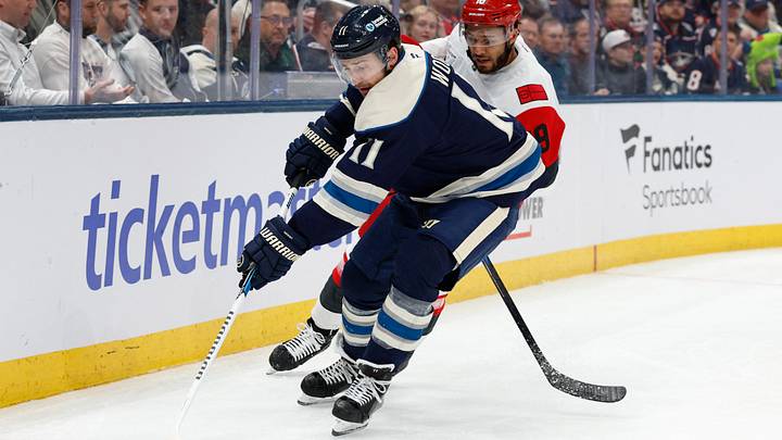 Mar 31, 2026; Columbus, Ohio, USA; Columbus Blue Jackets left wing Miles Wood (11) picks up the the loose puck as Carolina Hurricanes defenseman K'Andre Miller (19) defends during the second period at Nationwide Arena. Mandatory Credit: Russell LaBounty-Imagn Images
