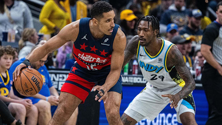 Nov 24, 2024; Indianapolis, Indiana, USA; Washington Wizards guard Malcolm Brogdon (15) dribbles the ball while   Indiana Pacers guard Quenton Jackson (29) defends in the first quarter at Gainbridge Fieldhouse. Mandatory Credit: Trevor Ruszkowski-Imagn Images