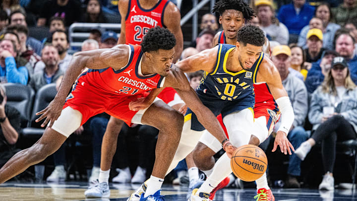 Nov 25, 2024; Indianapolis, Indiana, USA;  Indiana Pacers guard Tyrese Haliburton (0) and New Orleans Pelicans center Yves Missi (21) fight for the ball in the first half at Gainbridge Fieldhouse. Mandatory Credit: Trevor Ruszkowski-Imagn Images