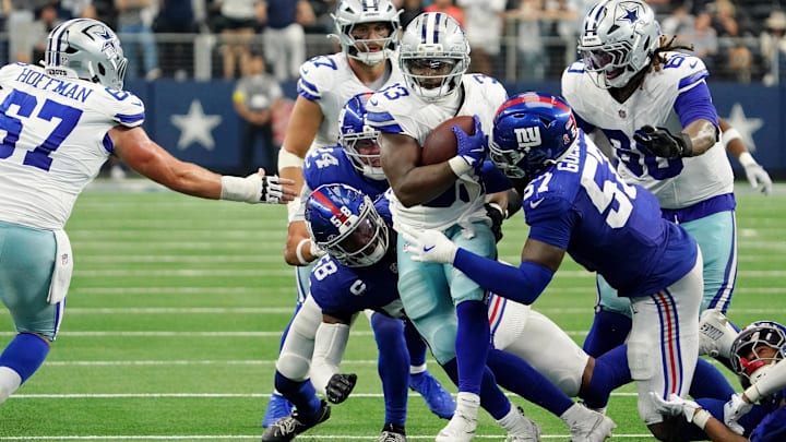 Sep 14, 2025; Arlington, Texas, USA; Dallas Cowboys running back Javonte Williams (33) runs with the ball against New York Giants linebacker Bobby Okereke (58) and defensive end Chauncey Golston (57) during overtime at AT&T Stadium. Mandatory Credit: Raymond Carlin III-Imagn Images