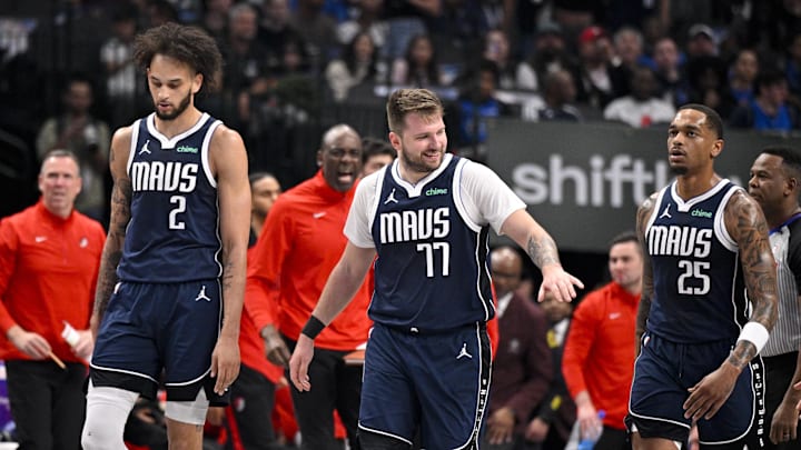 Dec 23, 2024; Dallas, Texas, USA; Dallas Mavericks center Dereck Lively II (2) and guard Luka Doncic (77) and forward P.J. Washington (25) walk back to the bench during a timeout in the game against the Portland Trail Blazers during the first quarter at the American Airlines Center. Mandatory Credit: Jerome Miron-Imagn Images