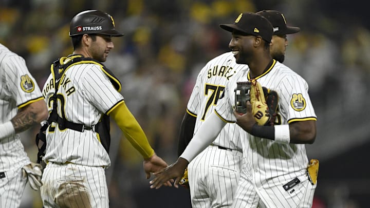 Oct 8, 2024; San Diego, California, USA; San Diego Padres catcher Kyle Higashioka (20) and outfielder Jurickson Profar (10) celebrate after defeating the Los Angeles Dodgers during game three of the NLDS for the 2024 MLB Playoffs at Petco Park. Mandatory Credit: Denis Poroy-Imagn Images Oct 8, 2024; San Diego, California, USA; San Diego Padres catcher Kyle Higashioka (20) and outfielder Jurickson Profar (10) celebrate after defeating the Los Angeles Dodgers during game three of the NLDS for the 2024 MLB Playoffs at Petco Park. Mandatory Credit: Denis Poroy-Imagn Images