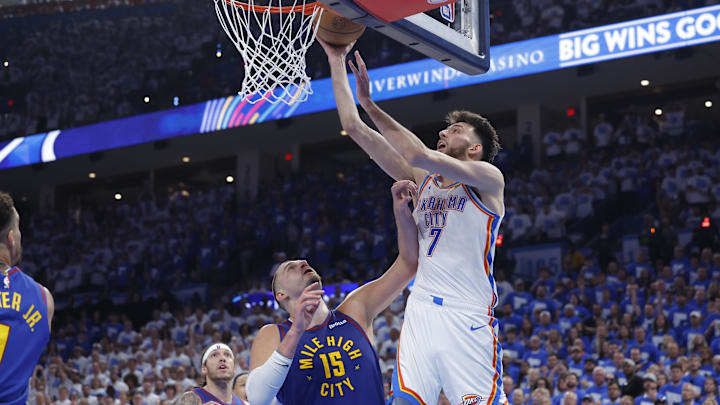 May 13, 2025; Oklahoma City, Oklahoma, USA; Oklahoma City Thunder forward Chet Holmgren (7) goes up for a basket over Denver Nuggets center Nikola Jokic (15) during the second half of game five of the second round for the 2025 NBA Playoffs at Paycom Center. Mandatory Credit: Alonzo Adams-Imagn Images