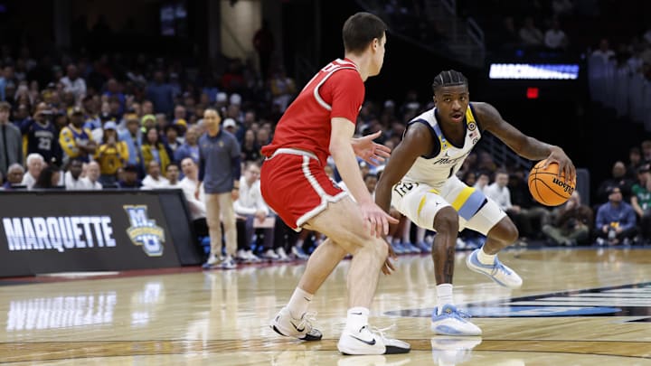 Mar 21, 2025; Cleveland, OH, USA; Marquette Golden Eagles guard Kam Jones (1) plays the ball defended by New Mexico Lobos forward Filip Borovicanin (8) in the first half  during the  NCAA Tournament First Round at Rocket Arena. Mandatory Credit: Rick Osentoski-Imagn Images