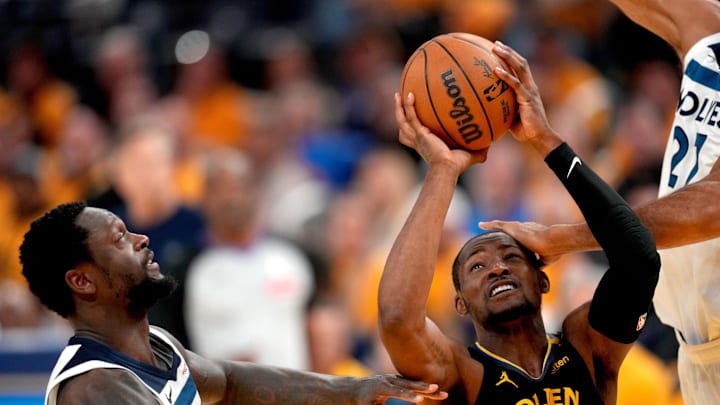 May 12, 2025; San Francisco, California, USA; Golden State Warriors forward Jonathan Kuminga (00) is fouled while attempting a shot between Minnesota Timberwolves forward Julius Randle (30) and center Rudy Gobert (27) in the fourth quarter during game four of the second round for the 2025 NBA Playoffs at Chase Center. Mandatory Credit: Cary Edmondson-Imagn Images