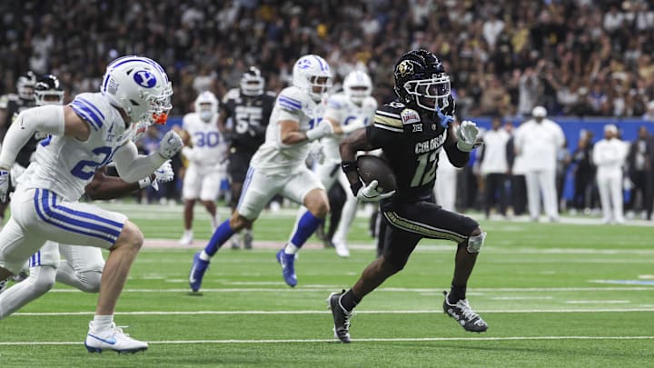 Dec 28, 2024; San Antonio, TX, USA; Colorado Buffaloes wide receiver Travis Hunter (12) runs with the ball and scores a touchdown during the third quarter against the Brigham Young Cougars at Alamodome. Mandatory Credit: Troy Taormina-Imagn Images Dec 28, 2024; San Antonio, TX, USA; Colorado Buffaloes wide receiver Travis Hunter (12) runs with the ball and scores a touchdown during the third quarter against the Brigham Young Cougars at Alamodome. Mandatory Credit: Troy Taormina-Imagn Images