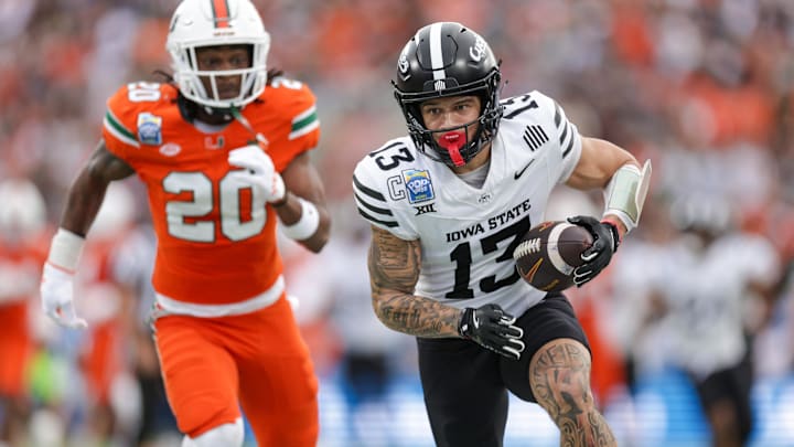 Dec 28, 2024; Orlando, FL, USA; Iowa State Cyclones wide receiver Jaylin Noel (13) runs with the ball against the Miami Hurricanes in the first quarter during the Pop Tarts bowl at Camping World Stadium. Mandatory Credit: Nathan Ray Seebeck-Imagn Images