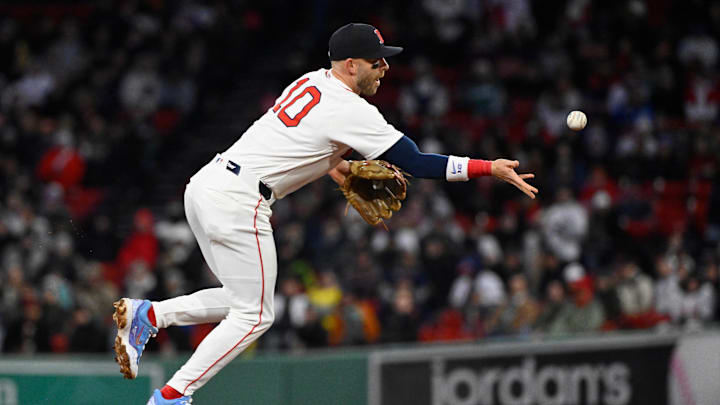 Apr 7, 2026; Boston, Massachusetts, USA; Boston Red Sox shortstop Trevor Story (10) tosses the ball to first base during the third inning against the Milwaukee Brewers at Fenway Park. Mandatory Credit: Eric Canha-Imagn Images
