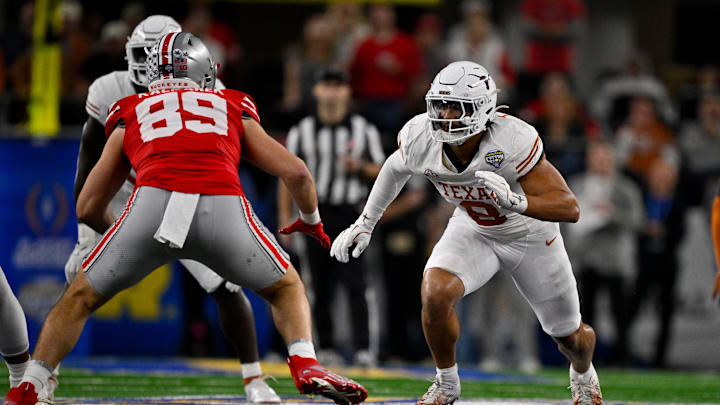 Jan 10, 2025; Arlington, TX, USA; Texas Longhorns linebacker Trey Moore (8) and Ohio State Buckeyes tight end Will Kacmarek (89) in action during the game between the Texas Longhorns and the Ohio State Buckeyes at AT&T Stadium. Mandatory Credit: Jerome Miron-Imagn Images Jan 10, 2025; Arlington, TX, USA; Texas Longhorns linebacker Trey Moore (8) and Ohio State Buckeyes tight end Will Kacmarek (89) in action during the game between the Texas Longhorns and the Ohio State Buckeyes at AT&T Stadium. Mandatory Credit: Jerome Miron-Imagn Images