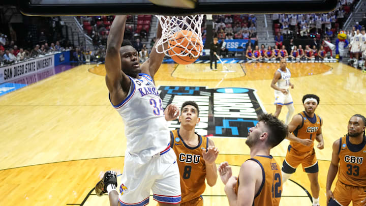 Mar 20, 2026; San Diego, CA, USA; Kansas Jayhawks center Paul Mbiya (34) dunks against the California Baptist Lancers in the first half during a first round game of the men's 2026 NCAA Tournament at Viejas Arena. Mandatory Credit: Kirby Lee-Imagn Images