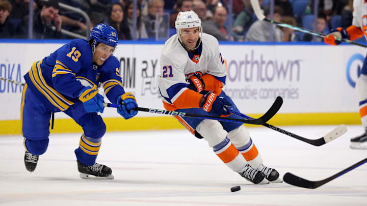 Mar 14, 2024; Buffalo, New York, USA;  Buffalo Sabres center Peyton Krebs (19) defends as New York Islanders center Kyle Palmieri (21) passes the puck during the first period at KeyBank Center. Mandatory Credit: Timothy T. Ludwig-USA TODAY Sports