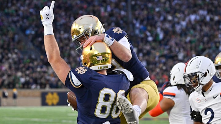 Nov 16, 2024; South Bend, Indiana, USA; Notre Dame Fighting Irish tight end Mitchell Evans (88) and quarterback Riley Leonard (13) celebrate after a touchdown in the second quarter against the Virginia Cavaliers at Notre Dame Stadium. Mandatory Credit: Matt Cashore-Imagn Images