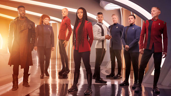 L-R David Ajala as Book, Mary Wiseman as Tilly, Doug Jones as Saru, Sonequa Martin-Green as Burnham, Wilson Cruz as Culber, Blu Del Barrio as Adira and Callum Keith Rennie as Raynor in season 5 of the Paramount+ original series STAR TREK: DISCOVERY. Photo Credit: James Dimmock/Paramount+