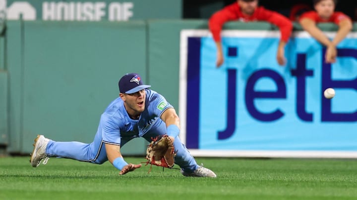 Boston, Massachusetts, USA; Toronto Blue Jays center fielder Daulton Varsho (25) attempts to catch a line drive during the seventh inning against the Boston Red Sox at Fenway Park.