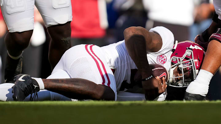 Alabama quarterback Jalen Milroe (4) dives onto a fumbled ball during an SEC conference game between Tennessee and Alabama in Neyland Stadium on Saturday, Oct. 19, 2024.