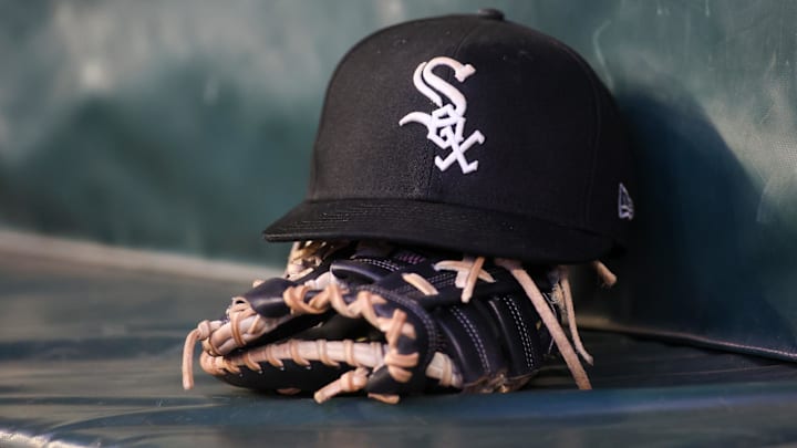 Jul 14, 2023; Atlanta, Georgia, USA; A detailed view of a Chicago White Sox hat and glove in the dugout against the Atlanta Braves in the fourth inning at Truist Park. Mandatory Credit: Brett Davis-Imagn Images