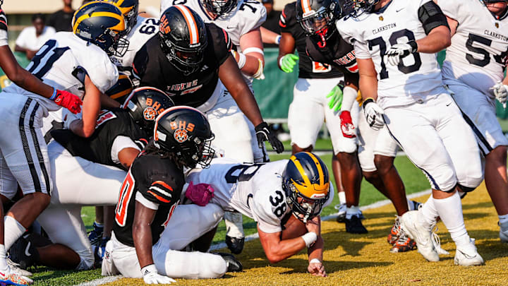Clarkston's Griffin Bowman makes a running touchdown late in the fourth quarter against Belleville during the 2024 Xenith Prep Kickoff Classic at Wayne State's Tom Adams Field in Detroit on Friday, Aug. 30, 2024.