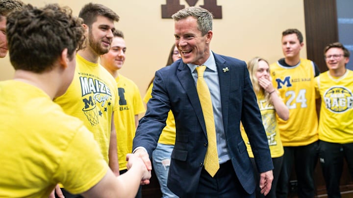 U-M's new men's basketball head coach Dusty May shakes hands with students section Maize Rage U-M's new men's basketball head coach Dusty May shakes hands with students section Maize Rage