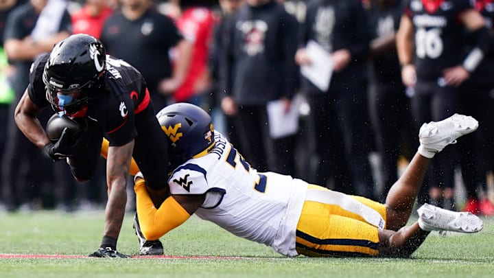 West Virginia Mountaineers safety Jaheem Joseph (3) tackles Cincinnati Bearcats wide receiver Xzavier Henderson (8) in the first quarter of a college football game between the Cincinnati Bearcats and West Virginia Mountaineers, Saturday, Nov. 9, 2024, at Nippert Stadium in Cincinnati.