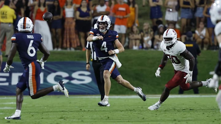 Sep 20, 2025; Charlottesville, Virginia, USA; Virginia Cavaliers quarterback Chandler Morris (4) passes the ball to Cavaliers wide receiver Cam Ross (6) as Stanford Cardinal linebacker Ese Dubre (30) chases during the second quarter at Scott Stadium. Mandatory Credit: Geoff Burke-Imagn Images Sep 20, 2025; Charlottesville, Virginia, USA; Virginia Cavaliers quarterback Chandler Morris (4) passes the ball to Cavaliers wide receiver Cam Ross (6) as Stanford Cardinal linebacker Ese Dubre (30) chases during the second quarter at Scott Stadium. Mandatory Credit: Geoff Burke-Imagn Images