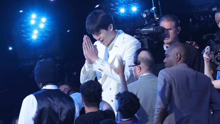 Jun 25, 2025; Brooklyn, NY, USA;  Yang Hansen walks to the stage after being selected as the 16th pick by the Memphis Grizzlies in the first round of the 2025 NBA Draft at Barclays Center. Mandatory Credit: Brad Penner-Imagn Images