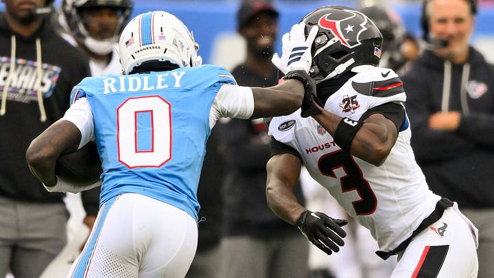 Oct 11, 2026; Nashville, Tennessee, USA;  Tennessee Titans wide receiver Calvin Ridley (0) stiff arms Houston Texans cornerback Kamari Lassiter (3) during the second half at Nissan Stadium. Mandatory Credit: Steve Roberts-Imagn Images