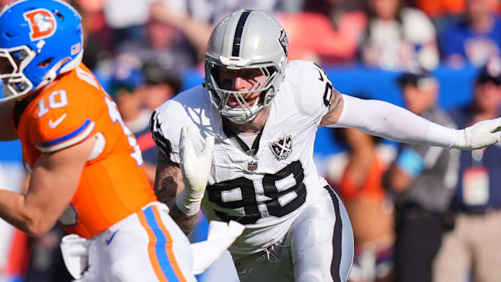 Oct 6, 2024; Denver, Colorado, USA; Las Vegas Raiders defensive end Maxx Crosby (98) chases down Denver Broncos quarterback Bo Nix (10) for a sack in the second half at Empower Field at Mile High. Mandatory Credit: Ron Chenoy-Imagn Images