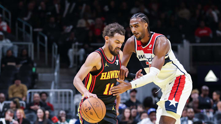 Nov 15, 2024; Atlanta, Georgia, USA; Washington Wizards forward Alexandre Sarr (20) fouls against Atlanta Hawks guard Trae Young (11) during the fourth quarter at State Farm Arena. Mandatory Credit: Jordan Godfree-Imagn Images
