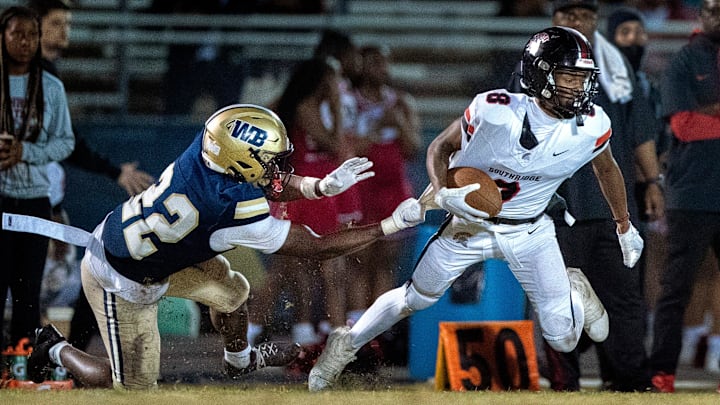 West Boca Marc-Sanchtz Lordeus grabs Miami Southridge receiver Darius Clements in the state semifinal game on December 6, 2024, in Boca Raton, Florida.