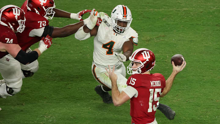 Jan 19, 2026; Miami Gardens, FL, USA; Indiana Hoosiers quarterback Fernando Mendoza (15) passes the ball under pressure by Miami Hurricanes defensive lineman Rueben Bain Jr. (4) in the third quarter during the College Football Playoff National Championship game at Hard Rock Stadium. Mandatory Credit: Kim Klement Neitzel-Imagn Images