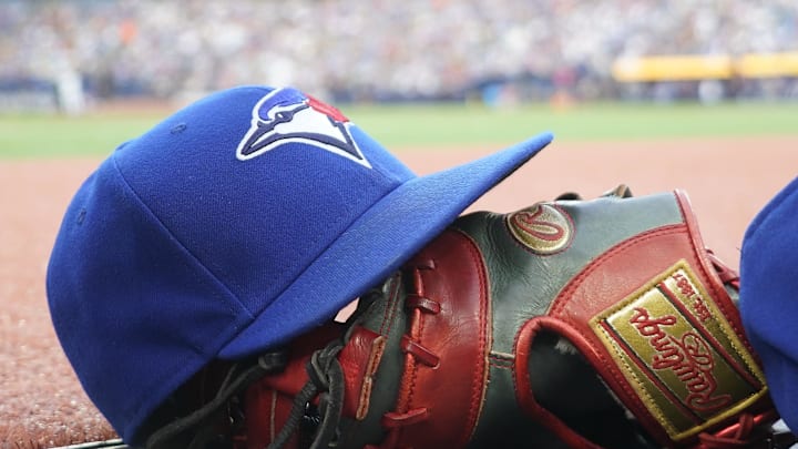 Jul 26, 2024; Toronto, Ontario, CAN; A Toronto Blue Jays hat and glove outside of the dugout during a game against the Texas Rangers at Rogers Centre. Mandatory Credit: John E. Sokolowski-Imagn Images Jul 26, 2024; Toronto, Ontario, CAN; A Toronto Blue Jays hat and glove outside of the dugout during a game against the Texas Rangers at Rogers Centre. Mandatory Credit: John E. Sokolowski-Imagn Images