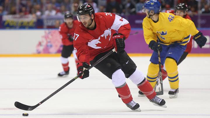 Feb 23, 2014; Sochi, RUSSIA; Canada forward Patrice Bergeron (37) skates with the puck against Sweden in the men's ice hockey gold medal game during the Sochi 2014 Olympic Winter Games at Bolshoy Ice Dome. Mandatory Credit: Winslow Townson-USA TODAY Sports