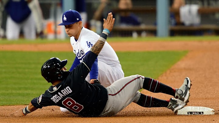 Dodgers shortstop Corey Seager (5) catches Atlanta Braves left fielder Eddie Rosario (8) stealing second in the third inning during game five of the 2021 NLCS at Dodger Stadium. Dodgers shortstop Corey Seager (5) catches Atlanta Braves left fielder Eddie Rosario (8) stealing second in the third inning during game five of the 2021 NLCS at Dodger Stadium.