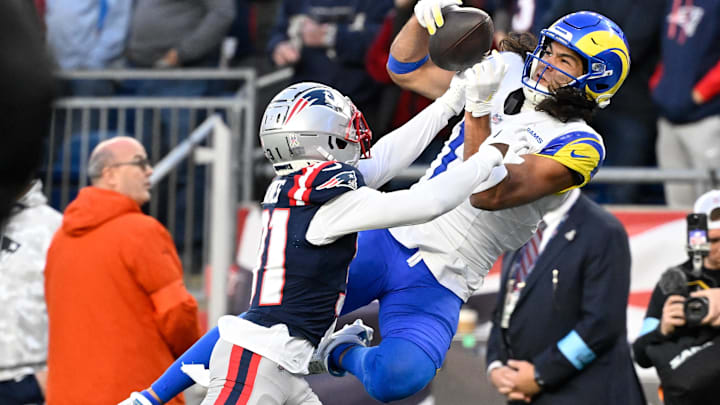 Nov 17, 2024; Foxborough, Massachusetts, USA;  New England Patriots cornerback Jonathan Jones (31) breaks up a pass to Los Angeles Rams wide receiver Puka Nacua (17) during the second half at Gillette Stadium. Mandatory Credit: Eric Canha-Imagn Images