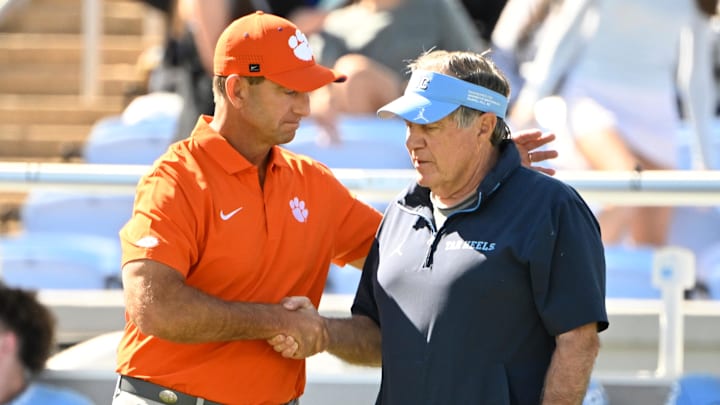Oct 4, 2025; Chapel Hill, North Carolina, USA; Clemson Tigers head coach Dabo Swinney with North Carolina Tar Heels head coach Bill Belichick before the game at Kenan Stadium. Mandatory Credit: Bob Donnan-Imagn Images