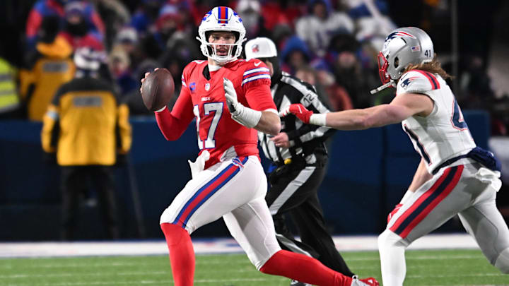 Dec 22, 2024; Orchard Park, New York, USA; Buffalo Bills quarterback Josh Allen (17) looks downfield to throw while avoiding New England Patriots safety Brenden Schooler (41) in the second quarter at Highmark Stadium. Mandatory Credit: Mark Konezny-Imagn Images