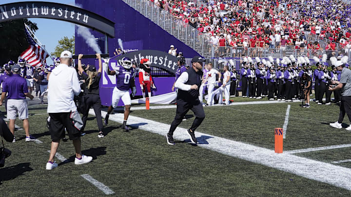 Aug 31, 2024; Evanston, Illinois, USA; Northwestern Wildcats head coach David Braun takes the field with his team against the Miami (Oh) Redhawks at Lanny and Sharon Martin Stadium. Mandatory Credit: David Banks-Imagn Images Aug 31, 2024; Evanston, Illinois, USA; Northwestern Wildcats head coach David Braun takes the field with his team against the Miami (Oh) Redhawks at Lanny and Sharon Martin Stadium. Mandatory Credit: David Banks-Imagn Images
