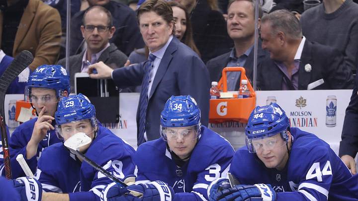 Feb 22, 2018; Toronto, Ontario, CAN; Toronto Maple Leafs William Nylander (29), Auston Matthews (34), and defenseman Morgan Rielly (44) look on as head coach Mike Babcock watches from behind the bench against the New York Islanders at Air Canada Centre. The Maple Leafs beat the Islanders 4-3 in the shootout. Mandatory Credit: Tom Szczerbowski-Imagn Images