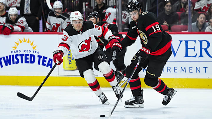 Ottawa Senators right wing Drake Batherson (19) plays the puck against New Jersey Devils left wing Evgenii Dadonov (33): David Kirouac-Imagn Images