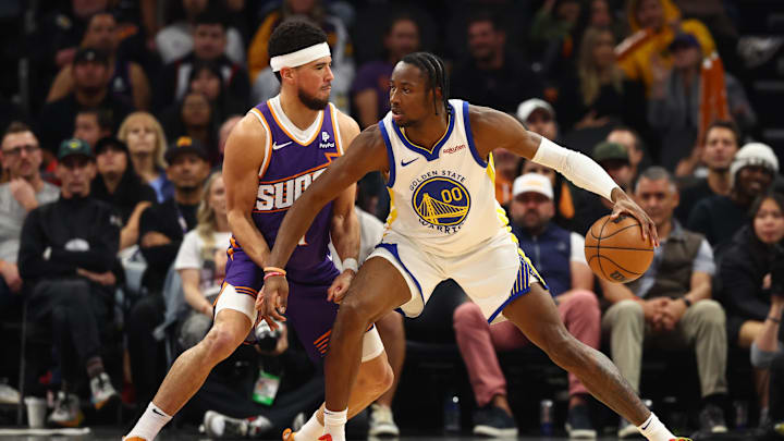 Dec 12, 2023; Phoenix, Arizona, USA; Golden State Warriors forward Jonathan Kuminga (00) against Phoenix Suns guard Devin Booker (1) at Footprint Center. Mandatory Credit: Mark J. Rebilas-Imagn Images Dec 12, 2023; Phoenix, Arizona, USA; Golden State Warriors forward Jonathan Kuminga (00) against Phoenix Suns guard Devin Booker (1) at Footprint Center. Mandatory Credit: Mark J. Rebilas-Imagn Images