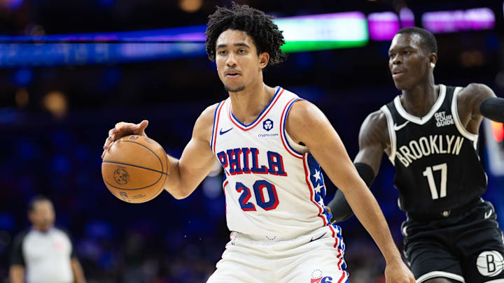 Oct 16, 2024; Philadelphia, Pennsylvania, USA; Philadelphia 76ers guard Jared McCain (20) dribbles the ball in front of Brooklyn Nets guard Dennis Schroder (17) during the fourth quarter at Wells Fargo Center. Mandatory Credit: Bill Streicher-Imagn Images