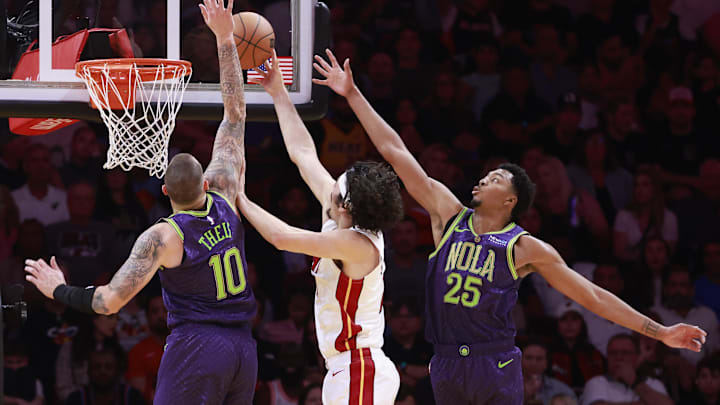 Jan 1, 2025; Miami, Florida, USA;  New Orleans Pelicans center Daniel Theis (10) and guard Trey Murphy III (25) defend Miami Heat guard Jaime Jaquez Jr. (11) during the first half at Kaseya Center. Mandatory Credit: Rhona Wise-Imagn Images