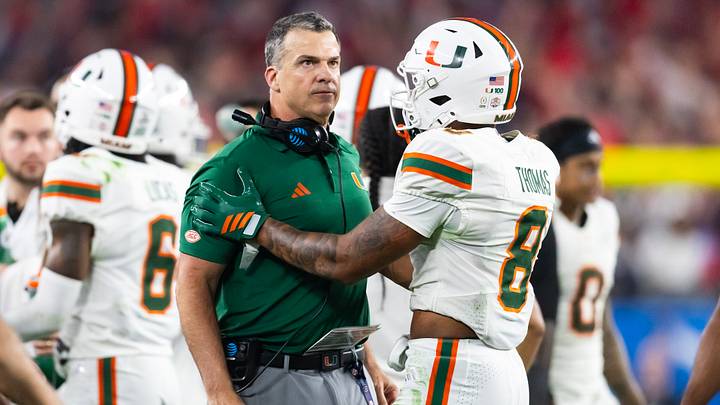 Jan 8, 2026; Glendale, AZ, USA; Miami Hurricanes head coach Mario Cristobal with defensive back Jakobe Thomas (8) against the Mississippi Rebels during the 2026 Fiesta Bowl and semifinal game of the College Football Playoff at State Farm Stadium. Mandatory Credit: Mark J. Rebilas-Imagn Images Jan 8, 2026; Glendale, AZ, USA; Miami Hurricanes head coach Mario Cristobal with defensive back Jakobe Thomas (8) against the Mississippi Rebels during the 2026 Fiesta Bowl and semifinal game of the College Football Playoff at State Farm Stadium. Mandatory Credit: Mark J. Rebilas-Imagn Images